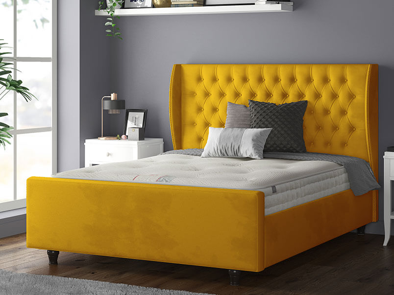 Aurora Chesterfield Wing Bed with Matching Buttons and Wooden Feet in Plush Velvet Turmeric